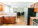 Open kitchen flows into the living room featuring hardwood floors, stainless steel appliances, and plenty of cabinet space at 123 Scheer Ave, Durham, NC 27703