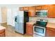 Modern kitchen design featuring stainless steel appliances, light countertops, and ample storage space in brown cabinets at 123 Scheer Ave, Durham, NC 27703