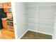 Spacious pantry with multiple shelves near kitchen with stainless steel appliances for organized storage at 123 Scheer Ave, Durham, NC 27703