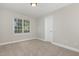 Bright bedroom featuring neutral walls, carpeted floor, and a window for natural light at 124 Cypress View Way, Apex, NC 27502