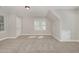 Large bonus room with a window, a door, neutral walls, and carpeted floor at 124 Cypress View Way, Apex, NC 27502