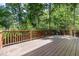 Wooden deck with wood railing overlooking lush greenery at 124 Cypress View Way, Apex, NC 27502
