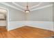 Dining room with hardwood floors, detailed molding, and a modern light fixture at 124 Cypress View Way, Apex, NC 27502