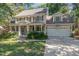 Charming two-story home with a covered front porch, landscaped yard, and a two-car garage at 124 Cypress View Way, Apex, NC 27502