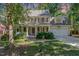 Charming two-story home with a covered front porch, landscaped yard, and a two-car garage at 124 Cypress View Way, Apex, NC 27502
