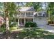 Charming two-story home with a covered front porch, landscaped yard, and a two-car garage at 124 Cypress View Way, Apex, NC 27502