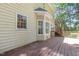 Wooden deck on yellow home, featuring window and bay window at 124 Cypress View Way, Apex, NC 27502