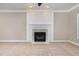 Bright living room with a white fireplace mantel, neutral walls and carpeting at 124 Cypress View Way, Apex, NC 27502