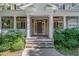 Inviting front porch with white columns, a dark wood door, and lush landscaping at 124 Cypress View Way, Apex, NC 27502