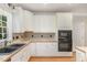 Bright kitchen showcasing white cabinets, wood countertops, and built in microwave and oven at 124 Cypress View Way, Apex, NC 27502