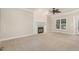 Spacious living room showcasing fireplace, neutral carpet and trim and natural light at 124 Cypress View Way, Apex, NC 27502