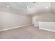 Spacious loft area with carpeted floor, neutral walls, and ceiling fan with integrated lights at 124 Cypress View Way, Apex, NC 27502