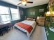 This bedroom features a large window, carpet, desk, and a bed with wood headboard at 129 Friar Ln, Carrboro, NC 27510