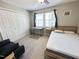 This bedroom offers a double door closet, desk, large window, and a bed with light colored headboard at 129 Friar Ln, Carrboro, NC 27510