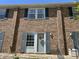 Charming brick townhome with blue shutters and a welcoming front entrance at 129 Friar Ln, Carrboro, NC 27510