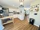 Bright kitchen featuring stainless steel appliances, white cabinets, and wood-look flooring at 129 Friar Ln, Carrboro, NC 27510