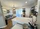 Well-lit kitchen featuring an island with white countertop and adjacent dining area at 129 Friar Ln, Carrboro, NC 27510