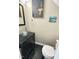 Modern powder room featuring a glass bowl sink, black vanity, and tiled flooring at 129 Friar Ln, Carrboro, NC 27510