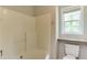 Bathroom features a tiled shower over tub and a toilet at 1310 Southgate Dr, Raleigh, NC 27610