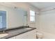 Bathroom features granite countertop, double vanity, and a shower-tub combo at 1310 Southgate Dr, Raleigh, NC 27610