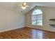 Vaulted bedroom with a large arched window and hardwood floors at 1310 Southgate Dr, Raleigh, NC 27610