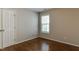 A well-lit bedroom featuring a door and large window at 1310 Southgate Dr, Raleigh, NC 27610