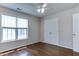 Bedroom features hardwood floors, a ceiling fan, and a window with blinds at 1310 Southgate Dr, Raleigh, NC 27610