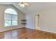 Vaulted bedroom featuring an arched window, hardwood floors and stone shelves at 1310 Southgate Dr, Raleigh, NC 27610