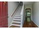 Welcoming entryway with hardwood floors and staircase leading to the upper level at 1310 Southgate Dr, Raleigh, NC 27610