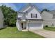 Charming two-story home with white siding, attached garage, and well-maintained lawn at 1310 Southgate Dr, Raleigh, NC 27610