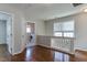 Upstairs hallway displaying hardwood floors, a window and a view to a laundry room at 1310 Southgate Dr, Raleigh, NC 27610