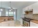 Well-lit kitchen featuring granite countertops, stainless steel appliances and an adjacent breakfast nook at 1310 Southgate Dr, Raleigh, NC 27610
