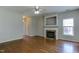 Spacious living room featuring hardwood floors, a fireplace, and a ceiling fan at 1310 Southgate Dr, Raleigh, NC 27610