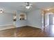 Open-concept living room with hardwood floors, leading to the kitchen area at 1310 Southgate Dr, Raleigh, NC 27610