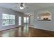 Bright living room with hardwood floors and large windows, seamlessly connected to kitchen at 1310 Southgate Dr, Raleigh, NC 27610