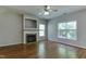 Bright living room with hardwood floors, fireplace, and large windows offering natural light at 1310 Southgate Dr, Raleigh, NC 27610