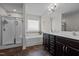 Bathroom featuring a soaking tub, shower with glass door, and a double vanity at 137 Campaign Dr, Mebane, NC 27302