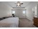 Spacious bedroom with a tray ceiling, carpeted floor, and natural light from the windows at 137 Campaign Dr, Mebane, NC 27302