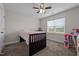 Cozy bedroom with a ceiling fan, carpeted floor, and natural light from a window at 137 Campaign Dr, Mebane, NC 27302