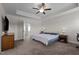Bright bedroom with a ceiling fan, carpeted floor, and natural light from the windows at 137 Campaign Dr, Mebane, NC 27302