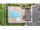 Aerial view of a large pool area, lounge chairs, and landscaping, with a clubhouse and parking nearby at 137 Campaign Dr, Mebane, NC 27302