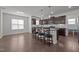 Bright kitchen has center island and bar stool seating open to an adjacent space at 137 Campaign Dr, Mebane, NC 27302