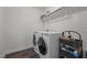 Well-lit laundry room featuring front load washer and dryer with storage shelving at 137 Campaign Dr, Mebane, NC 27302