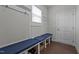 Mudroom with built-in seating, storage baskets, and a door to the outside at 137 Campaign Dr, Mebane, NC 27302