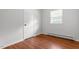 Bedroom features a window with blinds and wood-look flooring at 1512 Bacon St, Durham, NC 27701