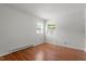Bedroom features two windows, an air conditioner, and wood-look flooring at 1512 Bacon St, Durham, NC 27701