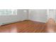 Bright, airy living room with freshly painted walls and pristine hardwood floors at 1512 Bacon St, Durham, NC 27701