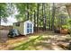 Spacious backyard with a shed, mature trees, and a charming back deck with a shade covering at 154 Jared Dr, Fuquay Varina, NC 27526