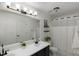 Modern bathroom with double vanity, ample lighting, and a shower with decorative curtain at 154 Jared Dr, Fuquay Varina, NC 27526