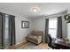 This bright bedroom features wood floors and a comfortable chair at 154 Jared Dr, Fuquay Varina, NC 27526